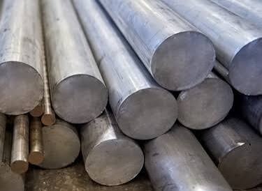 Stacked steel round bars &mdash; EN8, EN19, EN24, EN31 grades &mdash; at Dee Kay Traders Ghaziabad stockyard